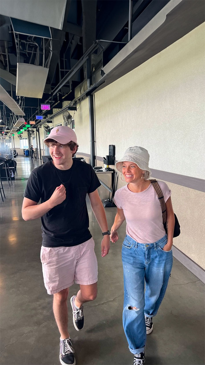 Mother and son walking through airport