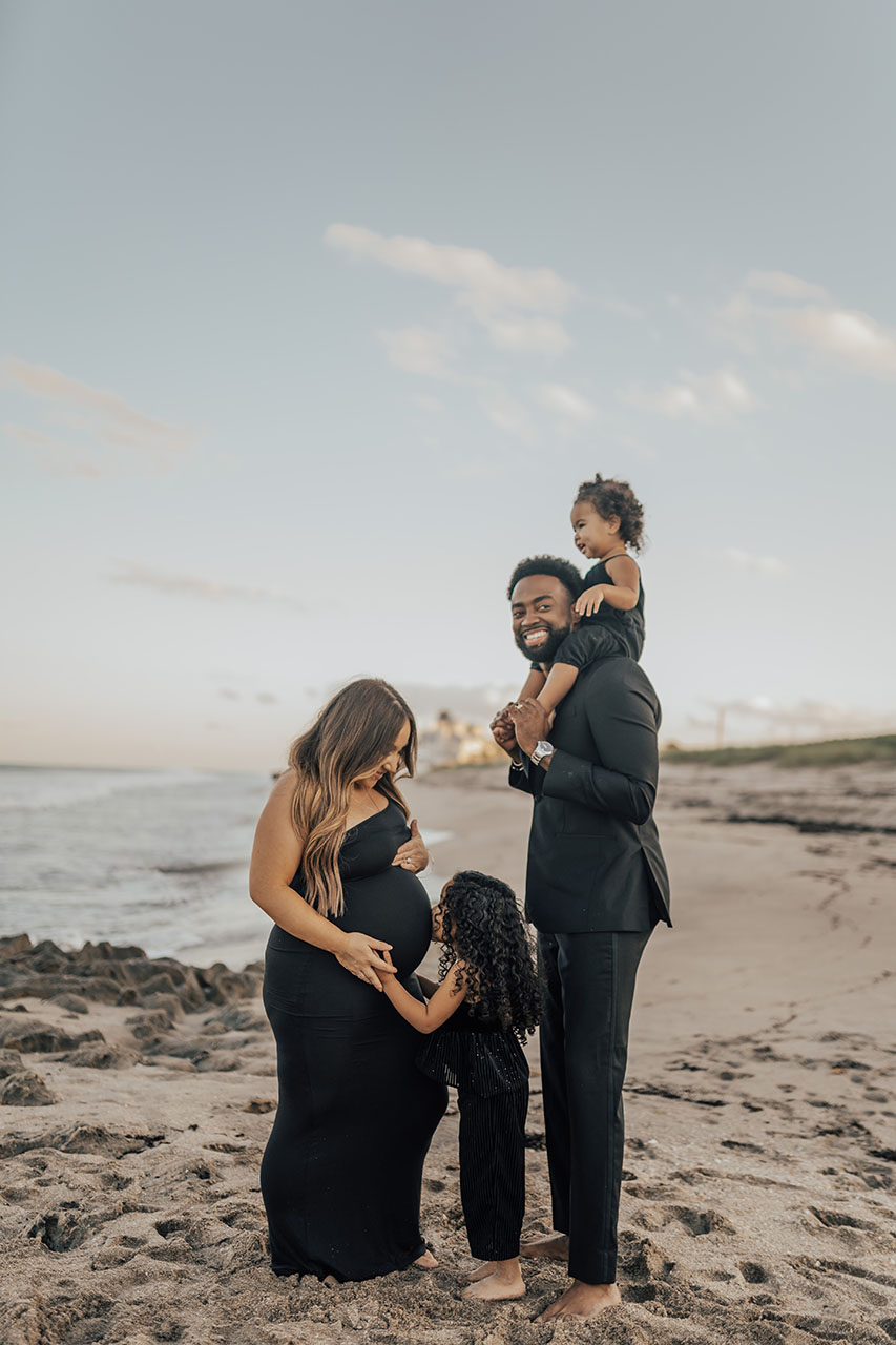 The Harvey family takes a candid photo on the beach in formal wear.